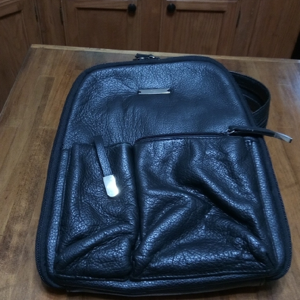 Sleek Black Backpack with Textured Finish and Silver Hardware